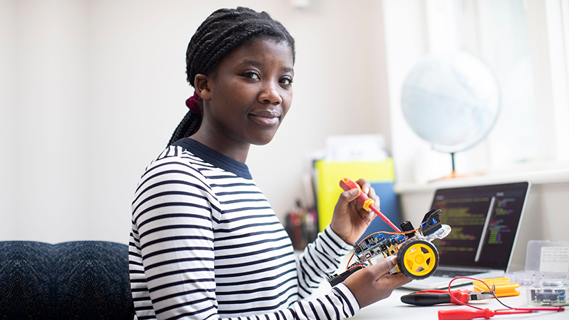 Portrait Of Female Teenage Pupil Building Robot Car In Science Lesson Portrait Of Female Teenage Pupil Building Robot Car In Science Lesson